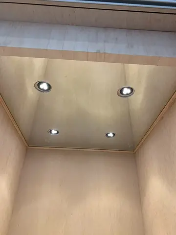 Ceiling mounted mirror with four round cutouts for lights installed by Glass Doctor of Nashville.