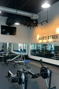 A gym with mirrors along two walls that were installed by Glass Doctor of Nashville.