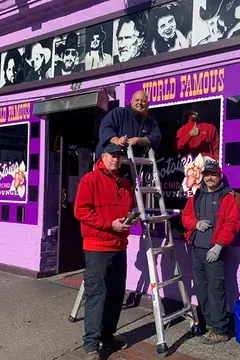 Glass Doctor of Nashville service professionals installing a glass window on the front of a business.
